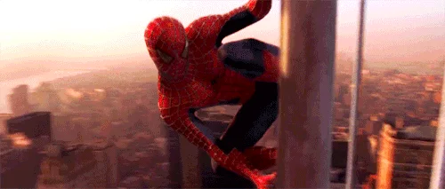 Spider-Man on a building in an action pose.