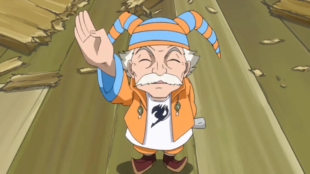 Master Makarov waves and looks up at Lucy with an adorable expression wearing his orange suit and jester orange and blue hat.