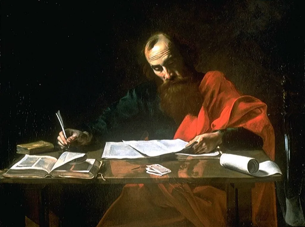 Painting of Saint Paul writing at a desk. The scene depicts Saint Paul, a bearded man with a contemplative expression, sitting at a wooden desk covered with papers and books. He is dressed in a robe, with a dark garment underneath and a bright red cloak draped over his shoulders. Paul is focused on his writing, holding a quill pen in his right hand and resting his left hand on an open book. The dimly lit background emphasizes the warm light illuminating his figure and workspace, creating a serene and studious atmosphere. The painting captures the moment of deep reflection and the intellectual effort of Saint Paul's writings.