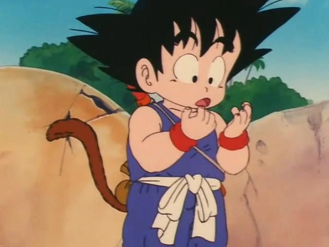 Goku examining his tiny hands in curiosity, probably wondering how such small hands hold so much power and potential!