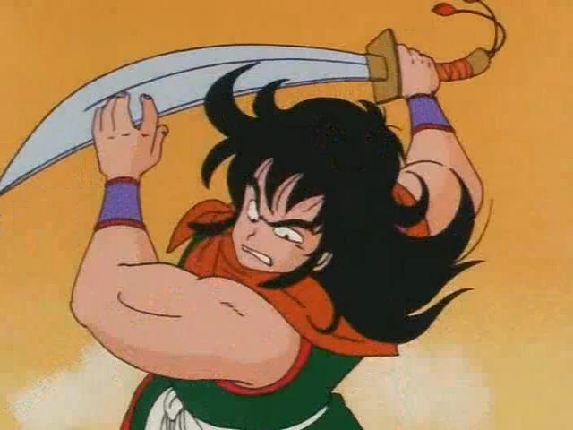 Yamcha brandishes his sword in Dragon Ball Episode 5, ready for an epic showdown. Catch the thrilling reaction on All Ages of Geek!