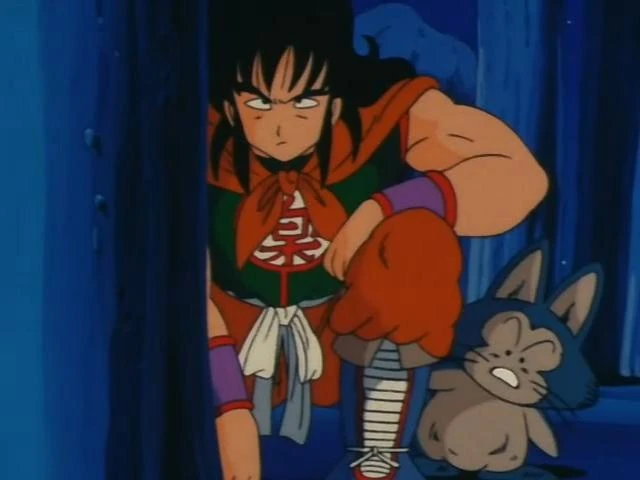 A determined and stealthy moment from Dragon Ball featuring Yamcha and Puar. Yamcha leans forward with a focused and serious expression, dressed in his black and orange outfit with a kanji symbol on his chest and a flowing red scarf. His fist is clenched as if preparing for action. Puar, his loyal blue cat-like companion, stands beside him, calm but alert. The dimly lit blue background and shadowed surroundings emphasize a sense of secrecy and readiness, capturing the adventurous spirit of the scene.