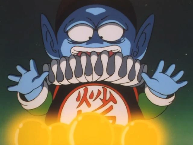 Emperor Pilaf grins mischievously, holding his hands over the glowing seven Dragon Balls, which radiate a golden light in the dark.