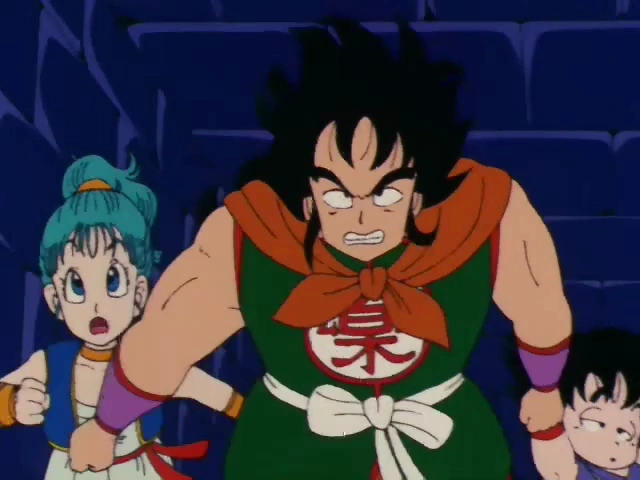 Yamcha stands in a defensive stance with a determined and angry expression, while Bulma looks shocked behind him. Goku, slightly obscured, is positioned to Yamcha's right, all set against the dark stone walls of Pilaf’s castle.