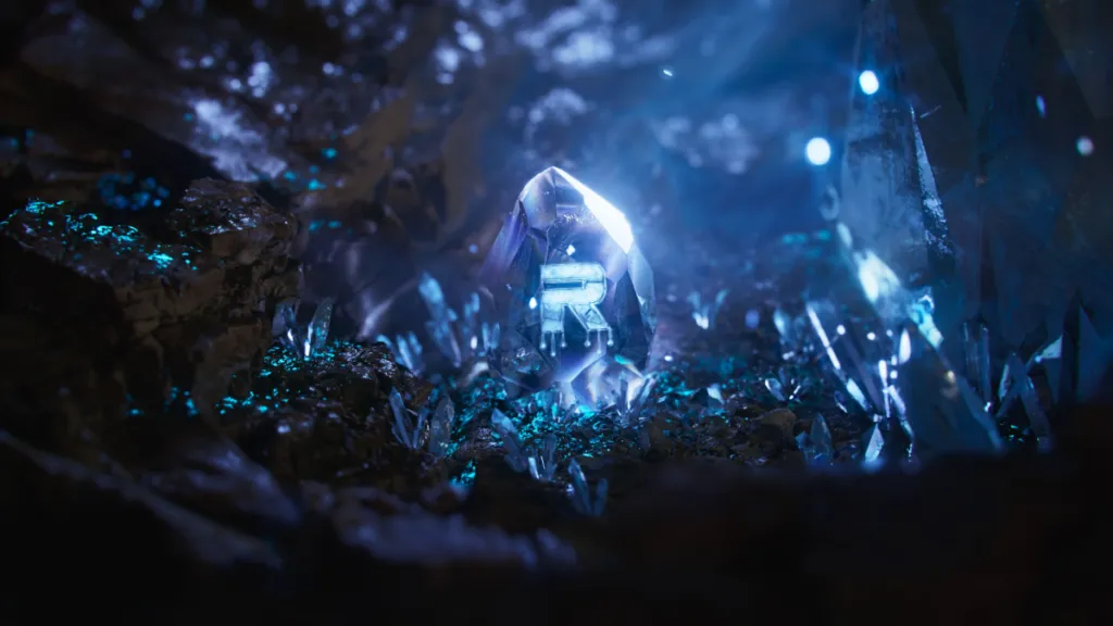 A glowing crystal with the letter "R" embedded, surrounded by an otherworldly environment of luminous blue crystals and rocky terrain, representing The Root Network.