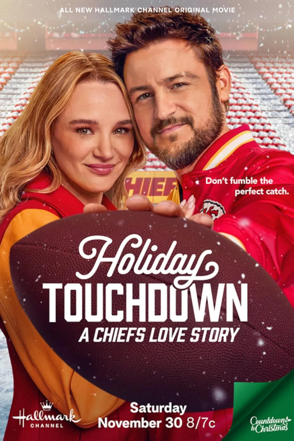 This is the poster for Holiday Touchdown: A Chiefs Love Story, a Hallmark holiday movie. It features a cozy, romantic scene with the two leads dressed in Kansas City Chiefs-themed jackets, hinting at a football-filled holiday backdrop. They’re smiling warmly, standing close together in a stadium dusted with snow and decked out in Christmas lights, blending sports and holiday magic. A football dominates the foreground with the title in bold, festive text, while the tagline, "Don’t fumble the perfect catch," adds a playful touch. It’s a charming mix of sports, romance, and holiday cheer!