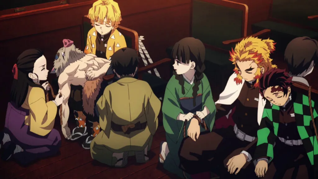 Screenshot from Demon Slayer showing Tanjiro, Zenitsu, Inosuke, Nezuko, and Rengoku resting together on a train.