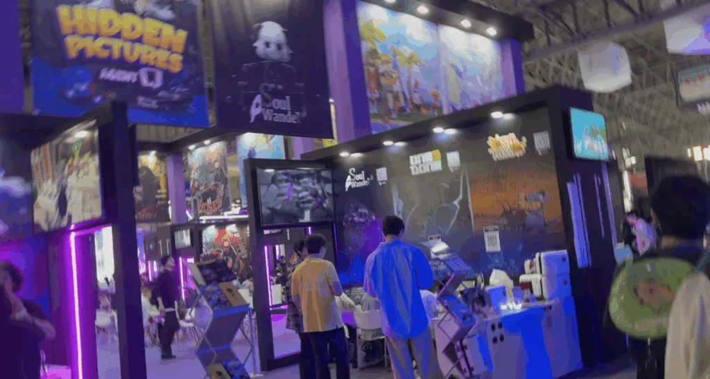 Visitors check out the Hidden Pictures and Soul Wander booths at Tokyo Game Show 2025, surrounded by glowing purple lights, colorful banners, and demo stations showcasing new games.