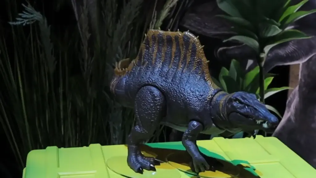 Jurassic Park dinosaur figure displayed at the Toy Fair NY 2025 Mattel showcase, featuring a detailed Spinosaurus model surrounded by jungle scenery.
