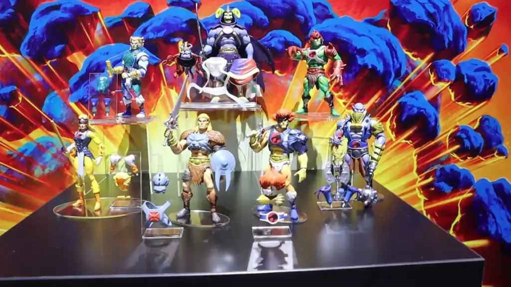 ThunderCats action figures showcased at the Toy Fair NY 2025 Mattel showcase, featuring Lion-O, Cheetara, and other classic characters posed with vibrant retro artwork in the background.
