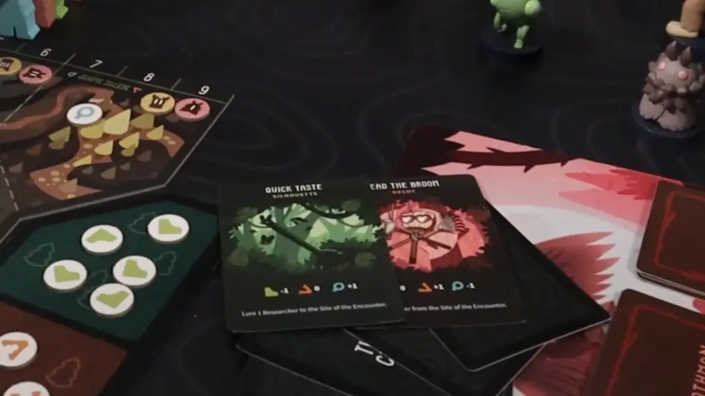 Twisted Cryptids action cards “Quick Taste” and “Read the Broom” featured at the Toy Fair NY 2025 Unstable Games showcase, displaying unique artwork and gameplay icons.