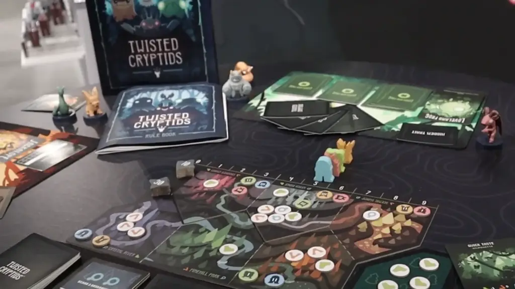 Twisted Cryptids rulebook and components on display at the Toy Fair NY 2025 Unstable Games showcase, highlighting the board design, player pieces, and cards in play.