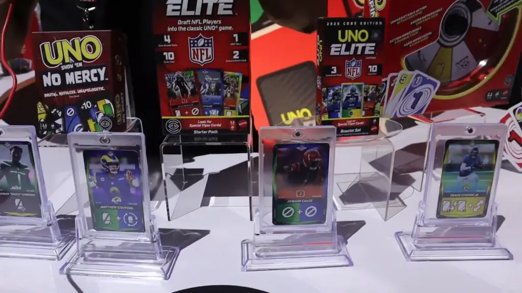 UNO Elite NFL trading card game sets featured at the Toy Fair NY 2025 Mattel showcase, showing collectible cards and booster packs inspired by professional football players.