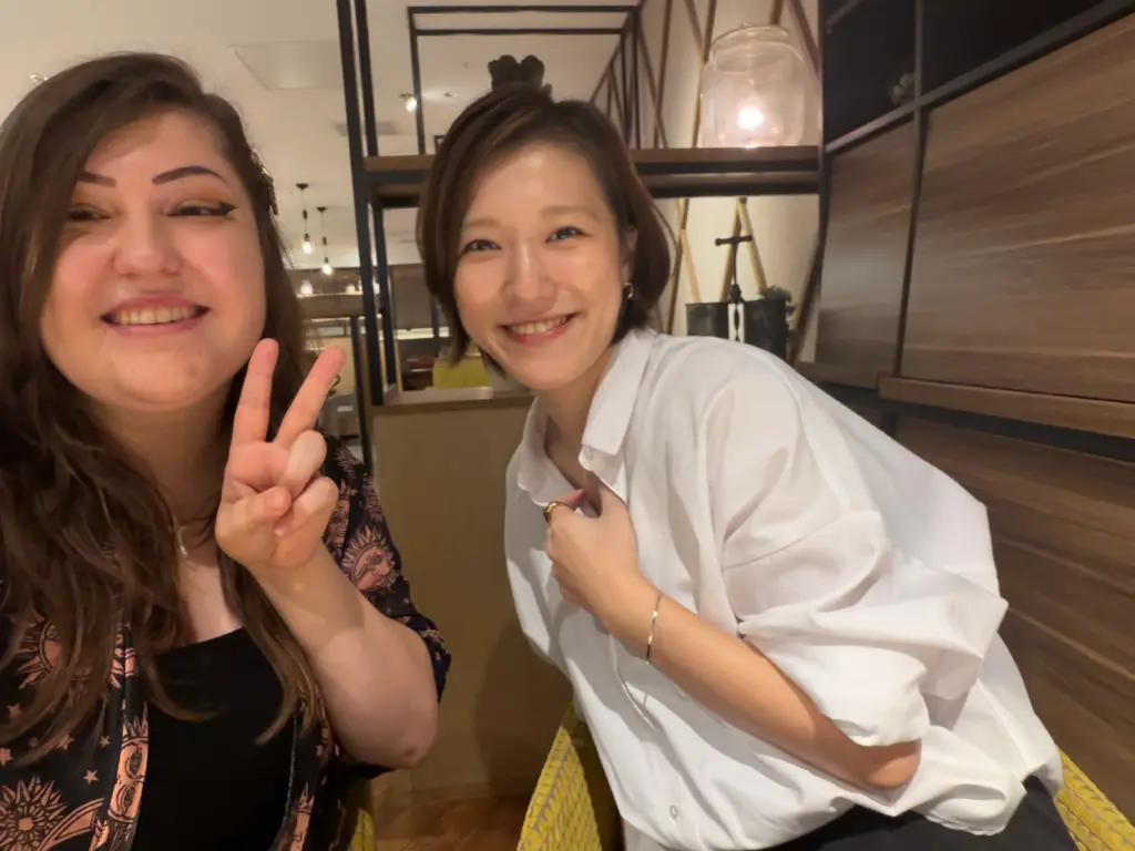 Tatiana Stec from All Ages of Geek and Japanese voice actress Yuui Hiromatsu smile together during an interview in Osaka, Japan.