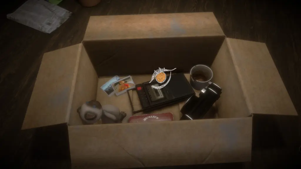 An open cardboard moving box on a wooden floor filled with personal items, including photos, a stuffed toy, a cassette recorder, a thermos, and a coffee mug, representing memories and objects explored in the game Before Closure.