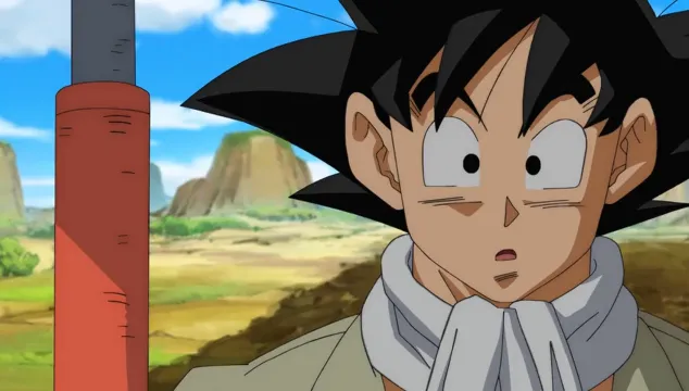 Goku standing in a farm setting wearing work clothes, looking surprised with wide eyes, with open fields and blue sky in the background.