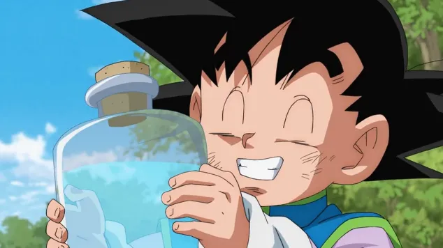 Young Goten smiling brightly while holding a glass bottle filled with glowing blue liquid, eyes closed in excitement, standing outdoors under a sunny sky.