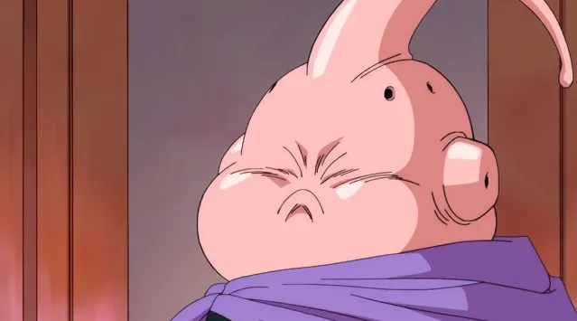 Close-up of Majin Buu with his eyes tightly shut and cheeks puffed out, wearing his purple cape, looking frustrated or stubborn inside a room with soft lighting.