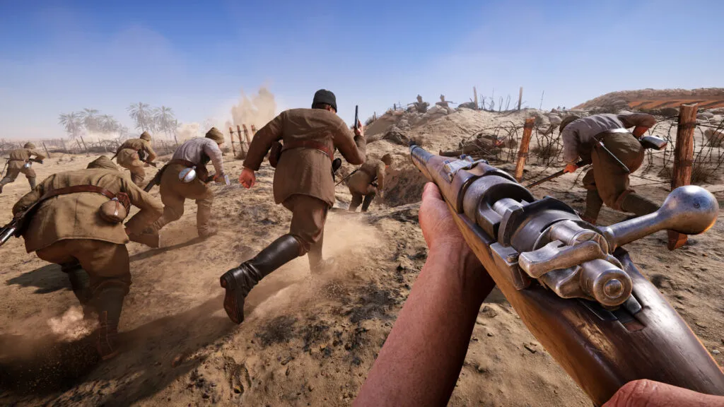 First-person view of a soldier charging across a desert battlefield with a rifle, following a squad advancing toward enemy trenches under fire and explosions.