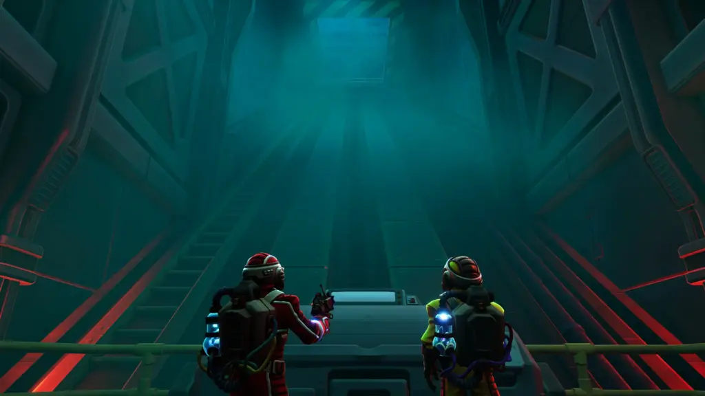 Two astronauts stand side by side in a dark vertical chamber, looking up at a massive structure as they prepare their next move.
